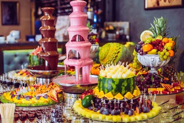 Peel and stick wall murals Dessert Delicious sweets and fruits on candy buffet. Lot of colorful desserts on table. Chocolate fountain. Party catering.