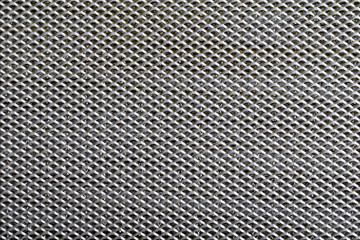  metal covered with lines of circular holes