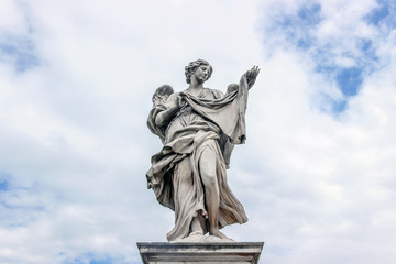 statue on Sant'Angelo bridge in cloudy sky in Rome 