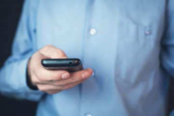 Businessman holding phone.