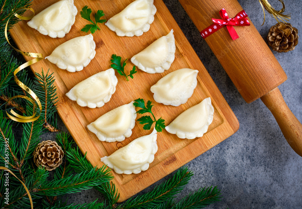 Wall mural christmas dumplings with decoration on a wooden board. top view.