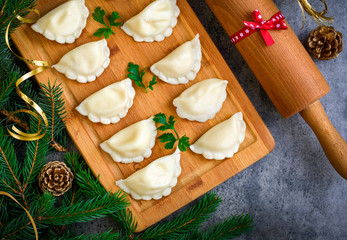 Christmas dumplings with decoration on a wooden board. Top view.