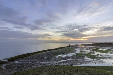 Sunset seascape of Olhao salt marsh Inlet waterfront to Ria Formosa natural park. Algarve.