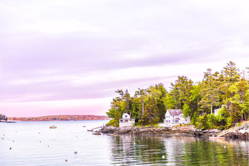 Sunset in evening at Boothbay Harbor in small village in Maine with rocky coast and houses in...