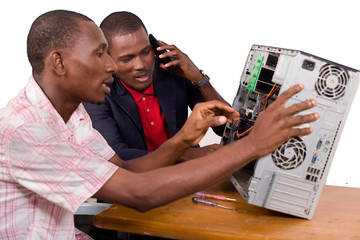 a team of computer scientists work together on a damaged computer