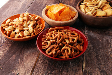 Salty snacks. Pretzels, chips, crackers in wooden bowls