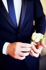 The bride wears a buttonhole for groom.