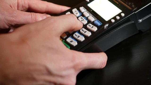 Hand insert credit card in pin pad of pos terminal.