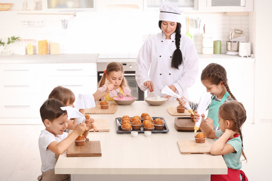 Group of children and teacher in kitchen during cooking classes