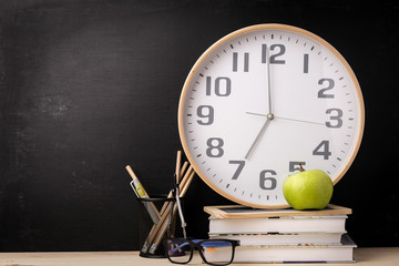 Arrangement of clock and school supplies