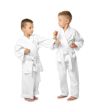 Little children practicing karate on white background