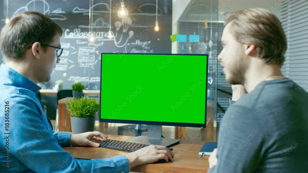 Poster two office employees have project related discussion, on the desk stands personal computer with mock