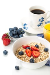 Bowl of Oats with Berry Toppings, Cup of Blueberries, and Cup of