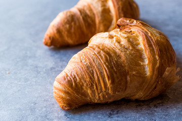 Freshly Baked Croissants on Blue Surface.