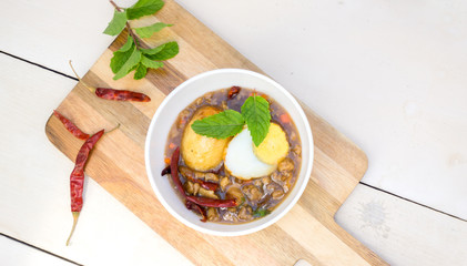 Egg with Tamarind Sauce on white wood