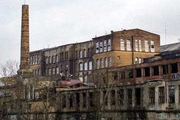 old abandoned factory with a stone pipe in the industrial zone