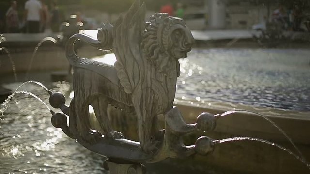 Fountain with mythical zodiac sculpture, relaxation on hot day, water streaming