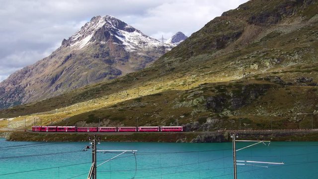 Alpine red train in Lago Bianco Ospizio on bernina pass glacier express in Switzerland