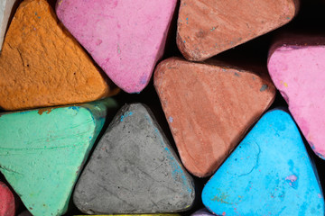 Large multi-colored chalk triangles in multiple colors