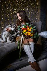 Beautiful girl in a Christmas atmosphere with puppies Husky