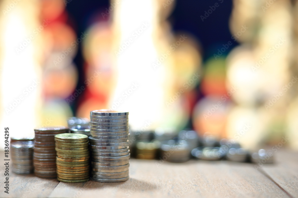 Poster coin pile stack on wood table and background of light bokeh. innovative business saving concept.