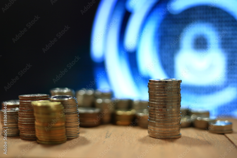 Poster vintage digital economy coin pile stacked in to columns on wooden board. digital binary code in the 
