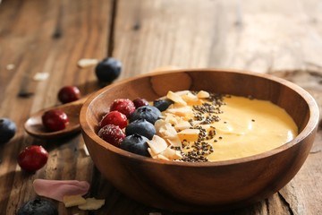 Mango Smoothie breakfast bowl  served in wooden bowl,selective focus