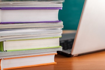 Stack of Books and Magazines with Laptop