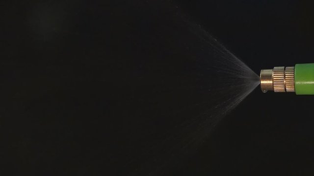 Slow motion sprinkler sprinkling agricultural water injection on black background, HD video