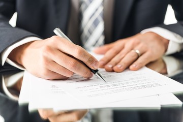 Closeup of a Businessman Signing a Contract