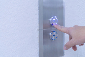 Using hands, press the elevator up and keypad elevator