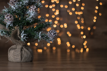 A little Christmas tree with christmas light background