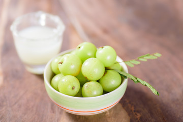 Indian gooseberry fruit and juice on wooden background,healthy food