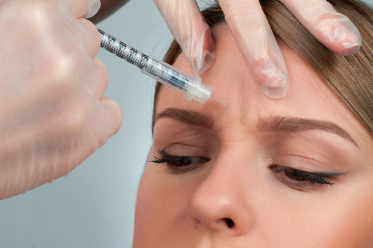 Woman receives injection for anti-aging treatment