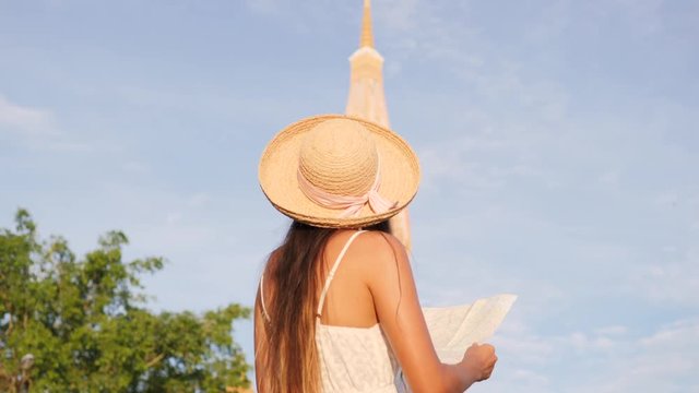 Young Hipster Tourist Woman Looking in Map at Traditional Thai Buddhist Temple. Thailand. 4K, Slowmotion.