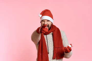joyful man points a finger forward, free space to copy, light pink background, new year
