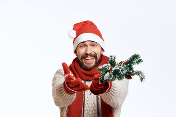 a man with a beard smiles, stretches forth his hands, artificial Christmas tree branches, a new year