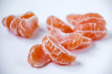 Orange mandarin slices on a light background