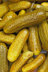 Pickles as background. Green pickle texture pattern. Pickled cucumber background. Texture closeup pattern. Vegetable.