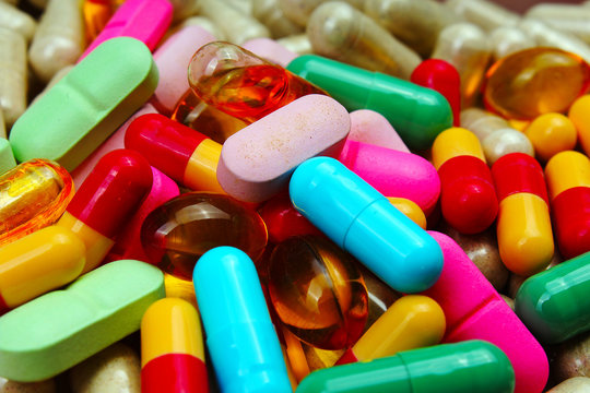 Medical or vitamin pills. Colorful medicine pills as texture. Pill pattern background. Green,red pink blue yellow.