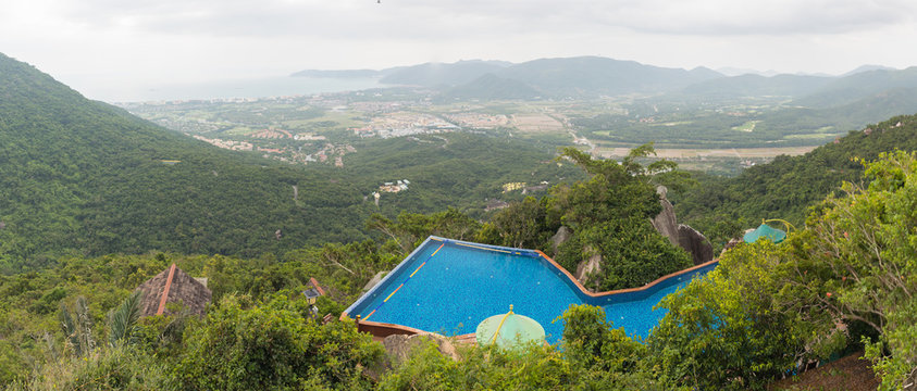 Pool in the mountains against the background of the rainforest and the sea © neonnspb