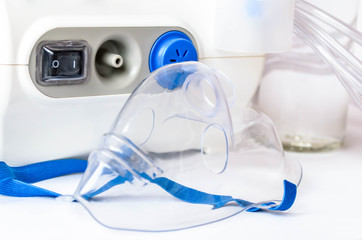 Medical equipment for inhalation, respiratory mask white background. Compressor nebulizer on white.