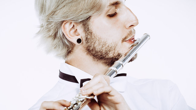 Male flutist playing his flute
