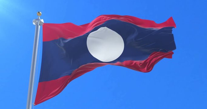 Flag of Laos waving at wind with blue sky in slow, loop
