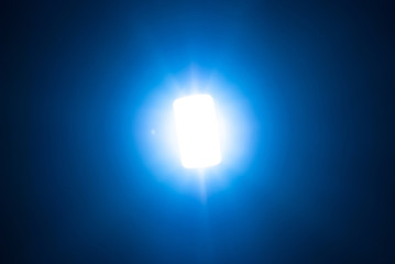 Blue light flare special effect,concert lighting against a dark background ilustration