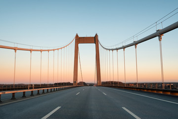 A bridge between Denmark and Sweden early in an autumn morning. A Danish-Swedish detective series of the same name is connected with this bridge. The picture is taken in direction of Denmark.