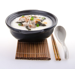 Traditional chinese pork porridge rice gruel served in claypot