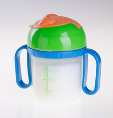 Baby bottle with milk on background