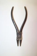 tool for work, simple iron pliers on a white background