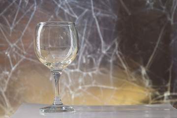 an empty wine glass on a silver background